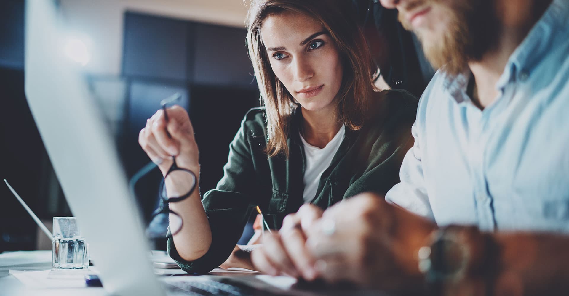 two people working at a laptop